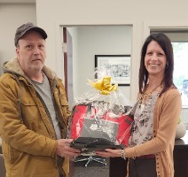 Prize winner holding gift basket.